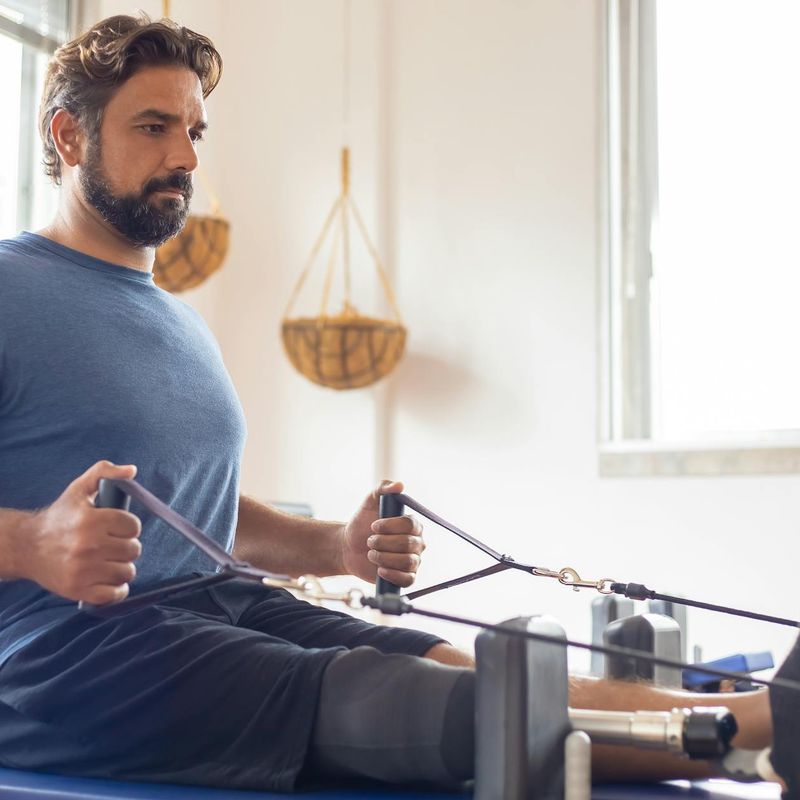 A focused man starting his workout routine in a spacious loft.